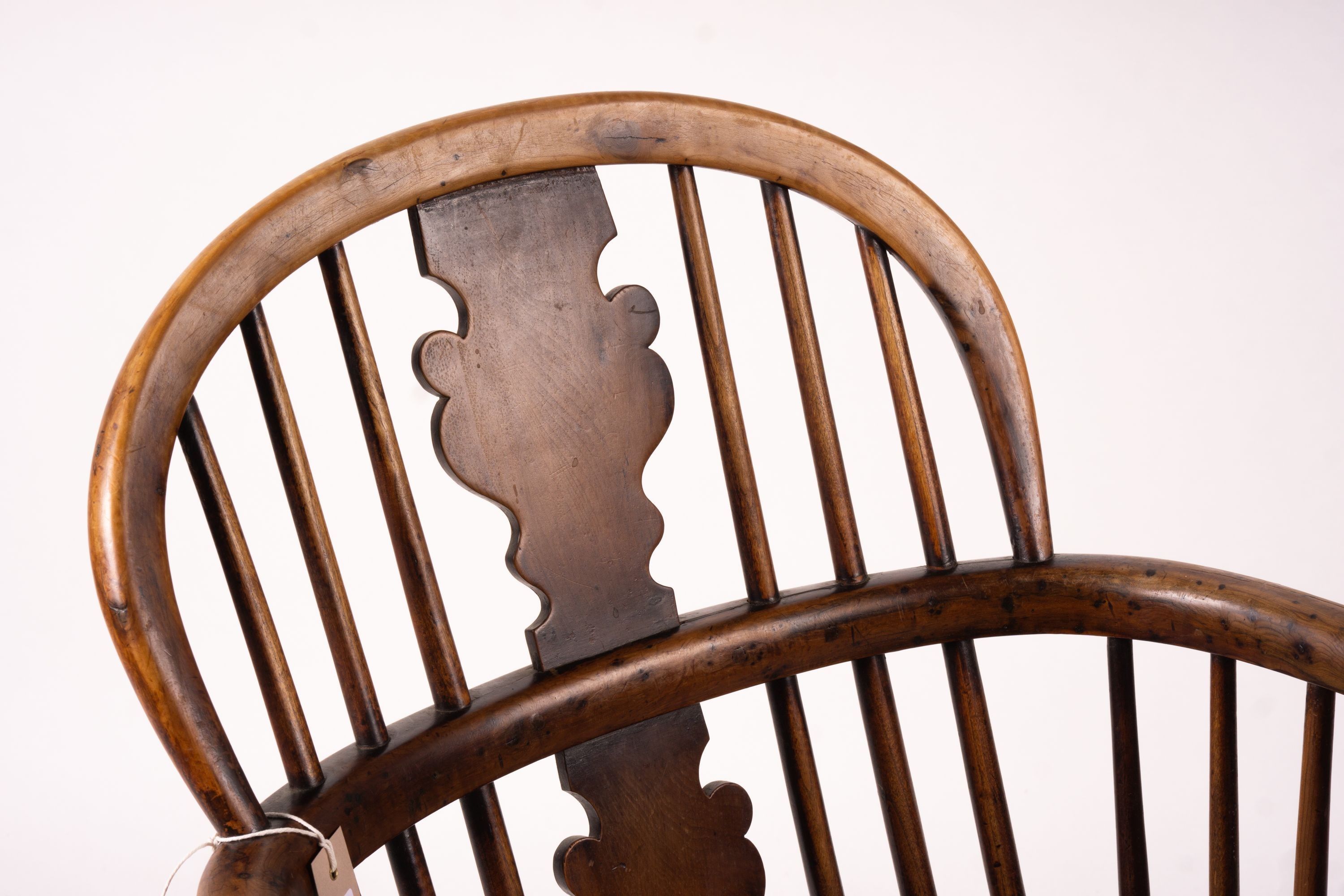 A mid 19th century yew and elm Windsor elbow chair with crinoline stretcher, width 54cm, depth 46cm, height 94cm